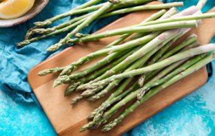 UNA SPECIALE LODE AGLI ASPARAGI asparagi verdi su tagliere
